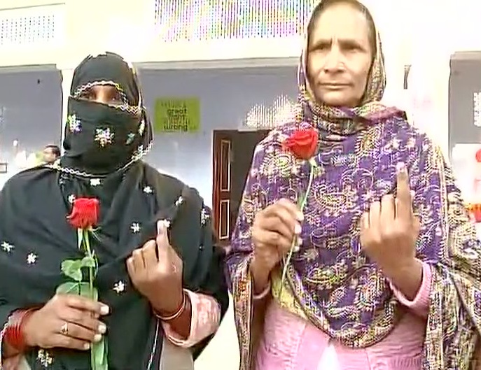 Women got a rose flower after casting their vote 