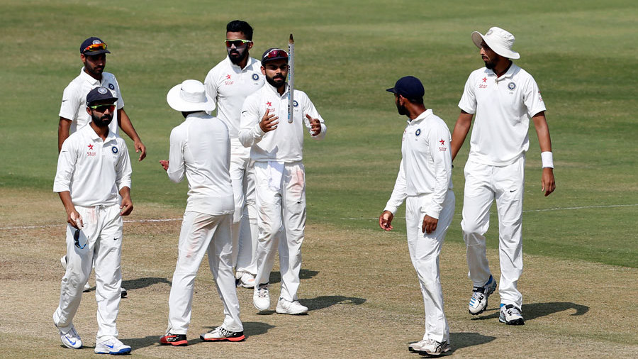 Virat Kohli takes a souvenir with him, after India's one-off Test victory against Bangladesh