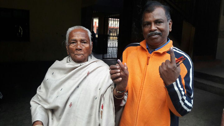 A man with old lady showing cast their vote in Kanpur, Uttar Pradesh 