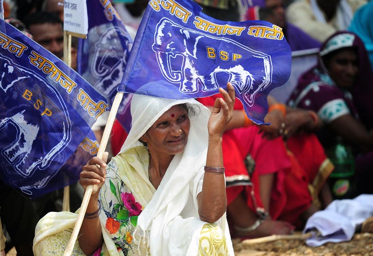 An aged woman holding a Bahujan Samaj Party 