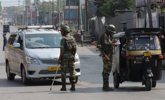 Security personnel stop vehicles during curfew, in Srinagar 