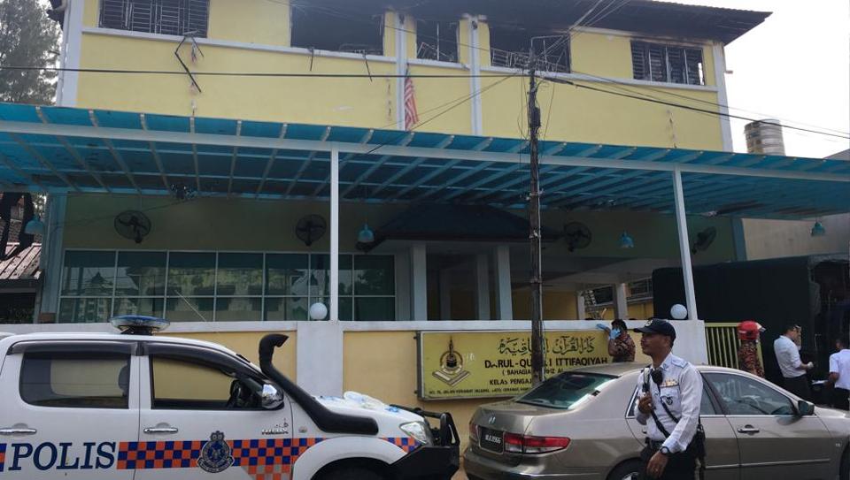 Police and fire department work at the religious school Darul Quran Ittifaqiyah after a fire broke out in Kuala Lumpur, Malaysia