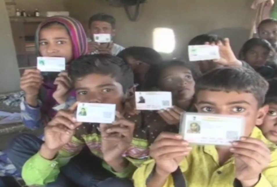 Children with their Aadhaar card