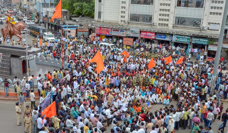 Maratha community members block the road during a protest against the government demanding reservation for Marathis