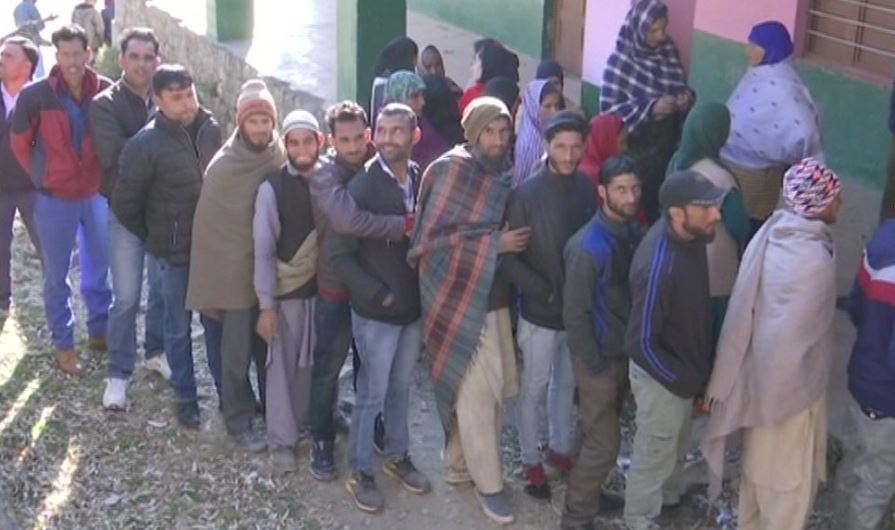 People standing in queue for casting their votes