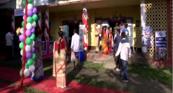 Voters line up outside polling booths 156 and 158 in Dibrugarh on Thursday
