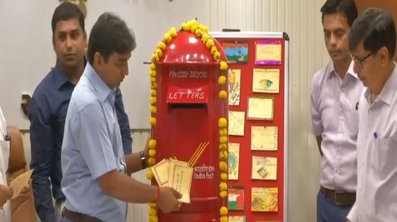 District Collector Vikrat Panday sending out postcard through India Post in Ahmedabad