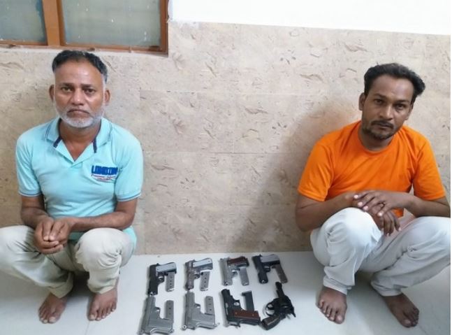 Arrested smugglers with seized arms and  ammunition
