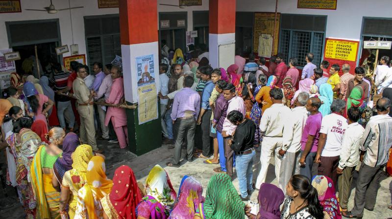 People Standing in queue to cast their vote