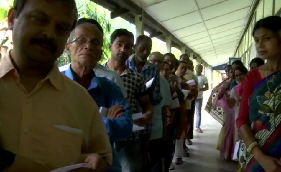 People queue up outside polling station number 224 in Dhubri to cast their votes