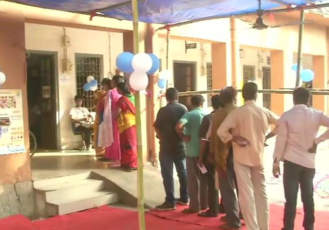 People standing in queue to cast vote