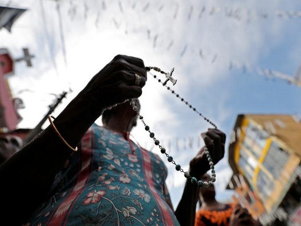 A woman holds a rosary as a tribute to the Easter Sunday terror attack