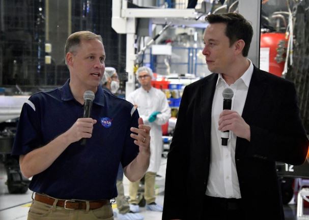 NASA Administrator Jim Bridenstine (L) and SpaceX Chief Engineer Elon Musk talk to the press after a tour of SpaceX headquarters in Hawthorne