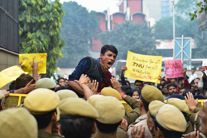 Police stop JNU students who were staging a protest over the hostel fee hike outside the UGC office at ITO in New Delhi