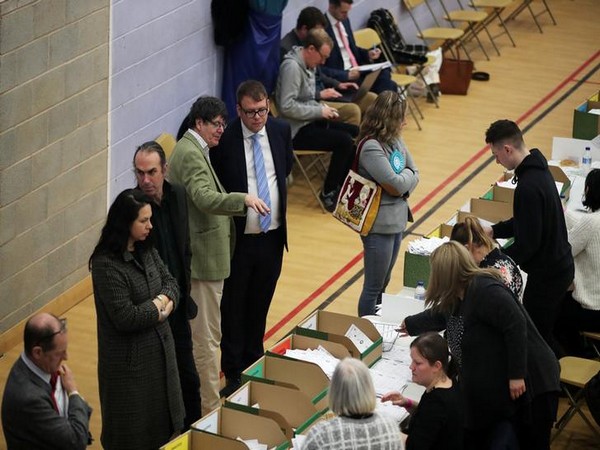 Conservative Party candidate Mark Fletcher watches as ballots are tallied at a counting centre in Britain