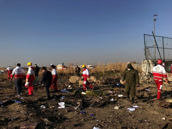 Rescue personnel at the site where a Ukraine International Airlines plane crashed near Tehran airport on Wednesday