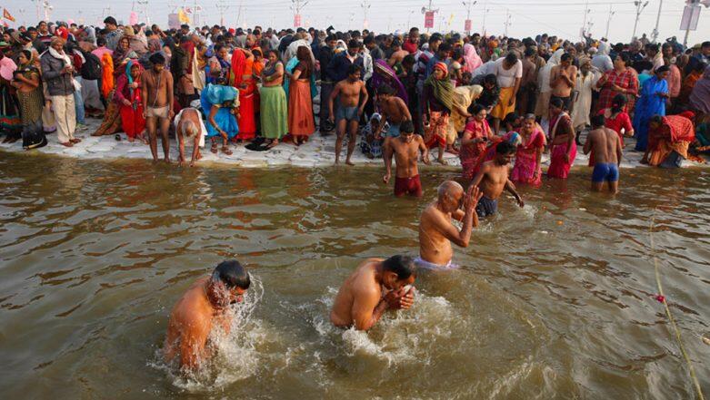Scores of devotees taking a holy dip in river Ganga on the first Monday of Sawan month in Varanasi.