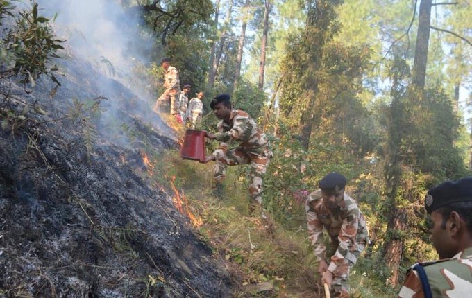 ITBP personnel douse fire in the Barahat range forests of the Uttarkashi district in Uttarakhand on Sunday.