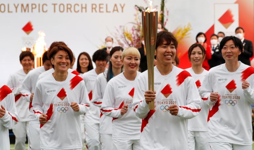 Tokyo 2020 Olympic Torch Relay Grand Start torchbearer Nadeshiko Japan, Japan's women's national soccer team, leads the torch relay in Naraha