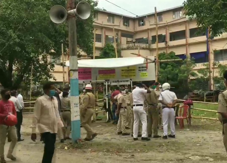 Officials, counting agents and others arrive at a counting centre at Siliguri College in Siliguri