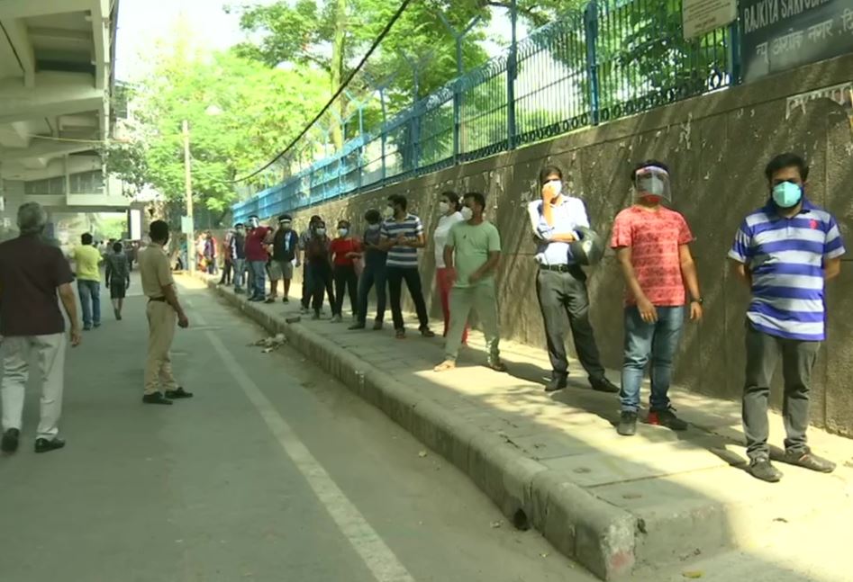 People above 18 years of age queue up outside a vaccination centre in Ashok Nagar