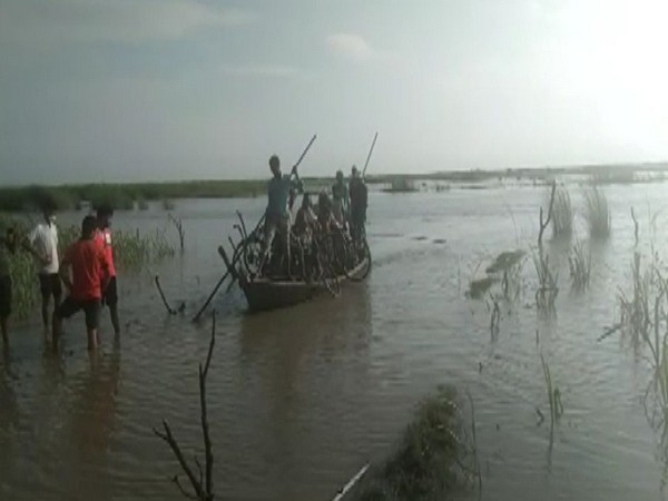 People being rescued after their boat got stuck in Gandak river, in Kushinagar on Friday.