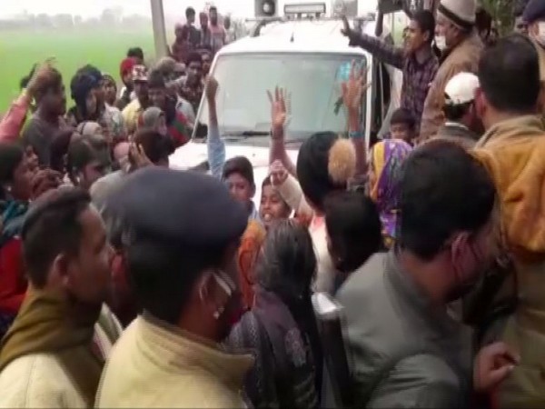 Local people in front of the minister's vehicle after the firing incident in Bihar's Champaran.
