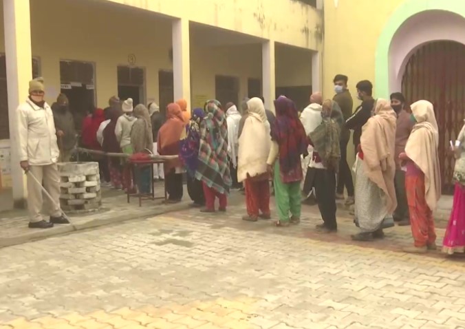 People queue up at Jain Inter College in Baghpat as they cast their votes