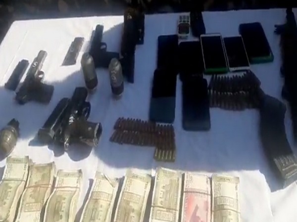 The seized cash, arms and ammunition with the Sopore Police.