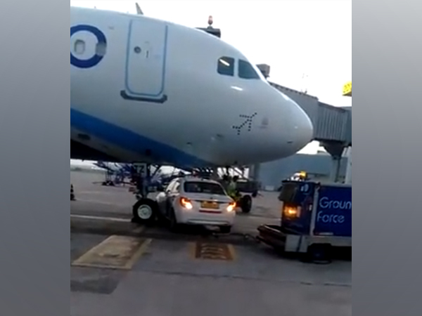 A Go First car stops under IndiGo Plane