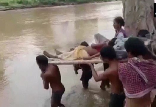 Tribal woman carried to hospital on a cot