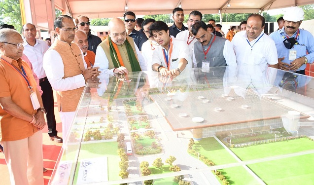 Union Home Minister Amit Shah reviews the model of Rajmata Vijayaraje Scindia Airport Terminal expansion