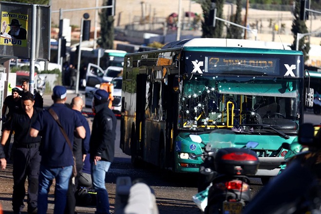 A damaged bus is seen following an explosion at a bus stop in Jerusalem