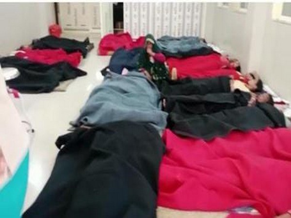 Women lying on ground during during sterilisation camp