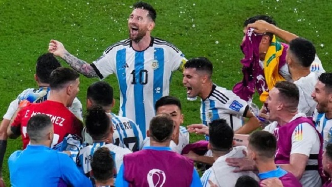 Argentina's Lionel Messi, top, celebrates with teammates