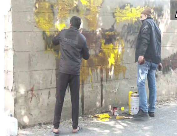 Visual of graffiti being removed from a wall in Delhi