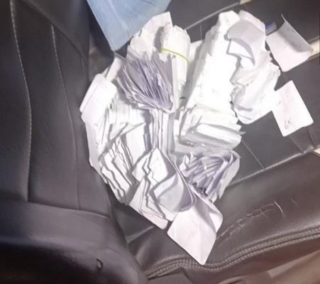 Election officials and police personnel seized money tokens from car