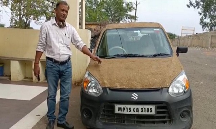 Doctor with his cow dung coated car
