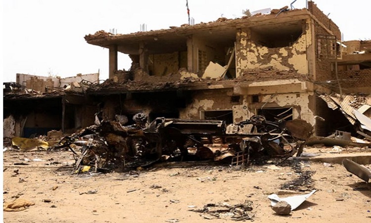 Damaged car and buildings are seen at the central market in Khartoum North