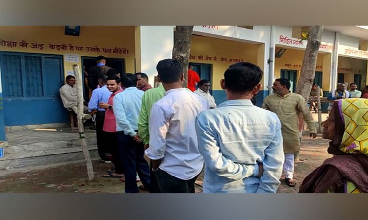 Voters stand in queue outside Shyamu Devi Polling Station