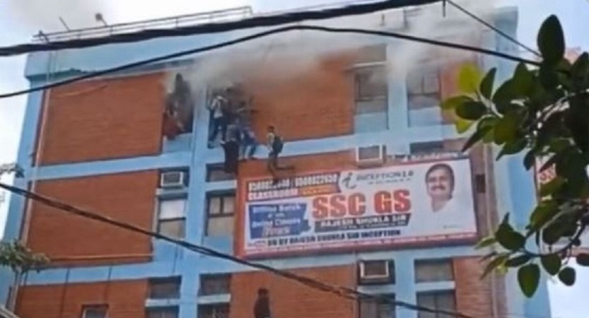 People abseil down from the building engulfed in fire for safety