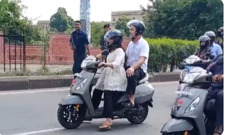 Rahul Gandhi rides pillion on a girl's scooter