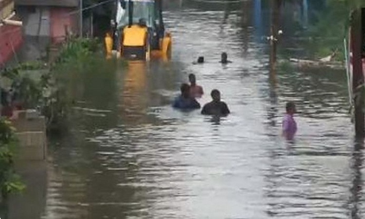 People wade through neck deep water in Chennai