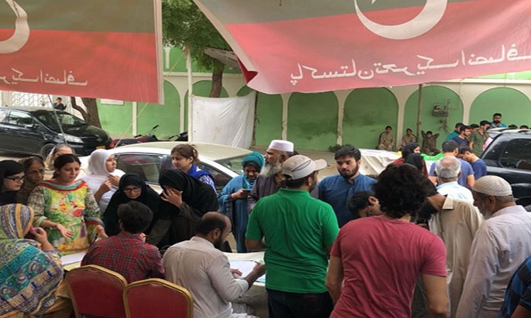 Representational Image  Voters queue up at a PTI bench near the voting centre