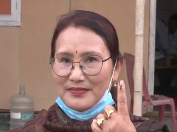 Voter shows inked finger after casting her vote
