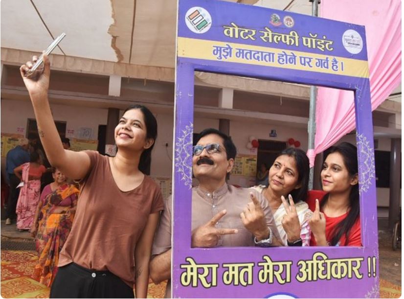 Voters take a selfie at a selfie point after casting their vote in Gwalior